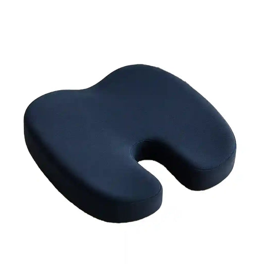 Coussin d'assise bleu profilé avec découpe arrière, posé près d'un livre et de lunettes