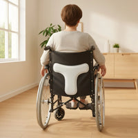 Coussin blanc à profil en T posé sur un fauteuil