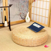 Coussin de sol rond beige clair à surface tressée